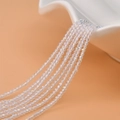 Macro detail of 2mm faceted transparent crystal beads with iridescent finish for jewelry - AB White