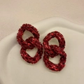 Elegant red crystal encrusted interlocking chain earrings shown on ceramic tray - Red Chain