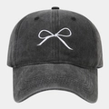 Close-up of white bow embroidery and washed dark gray cotton fabric on baseball cap - Adjustable / Black