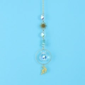 Detail of golden sun and moon精灵 crystal suncatcher with blue gravel and faceted glass ball - Blue Turquoise