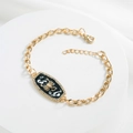 Detail of gold Scorpio constellation bracelet with black enamel and sparkling rhinestones - Scorpio