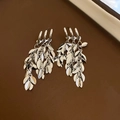 Detail view of silver tassel earrings with delicate metal leaf charms and multi-layer chains - Three-ring Leaf Chain Tassel (28#)