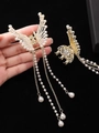Detailed close-up of golden butterfly hair claw with elegant hanging pearl tassels - Pearl Style