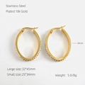 Detailed view of oval 18k gold plated stainless steel hoop earrings with zircon stones - Small