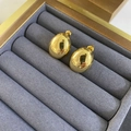 Detailansicht polierter goldener ovaler Ohrstecker in einer grauen Schmuckschatulle - Gold Klein