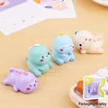 Set of four cute cartoon dinosaur resin figures in purple, green, blue and white colors - Blue Green Purple And Pinkish White Combo