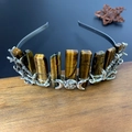 Macro detail of tiger eye crystals and silver triple moon goddess on the bridal headband - Tiger Eye + Triple Moon + Branch