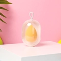 Gelber Make-up-Schwamm in transparenter Kapselhülle für ein perfektes Beauty-Blending - Orange Weltraumkapsel
