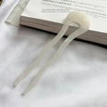 Macro view of wave-shaped cream acetate U-shaped hair pin with a pearlescent finish - Mermaid White