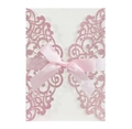 Macro detail of laser-cut glitter pink invitation card with silk ribbon bow - Pink
