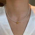 Natural freshwater pearl bracelet with a gold heart pendant on a woman's wrist - Natural Freshwater Pearl Heart Necklace