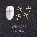 Macro view of 8x10mm gold cross nail art charms with crystal rhinestone inlay - Gold Cross with Clear Stone (A257)