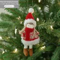 Christmas plush girl pendant in red knit sweater hanging on a decorated Xmas tree - Little Girl