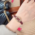 Elegant ladies' gold oval watch with deep red dial and red leather strap on wrist - Oval Bezel-24021