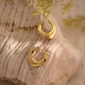 Detailed view of chunky heart-shaped gold hoop earrings with irregular hammered texture - Irregular Geometric Heart (EH285)