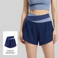 Women's yoga shorts in Whale Blue featuring a criss-cross high waistband and color-block design - S / Whale Blue