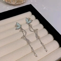 Pale green bow tassel earrings with silver chain and faux pearls on velvet display - Pale Green Butterfly Tassel (HSLE6102 Silver)