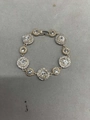 Elegant gold bracelet featuring alternating square and round sparkling rhinestone links - White