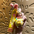 Pompompurin cartoon keychain featuring a 3D figure with a yellow silicone strap and gold hook - Sanrio Floral Series-Pompompurin