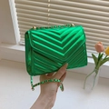 Glossy green patent leather crossbody bag with V-shaped quilting and gold chain strap - Green
