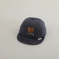 Close-up of baby baseball cap featuring brown bear embroidery and Lucky lettering details - 50cm 1-2 Years / Gray