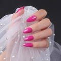 Glossy hot pink stiletto press-on nails with shiny UV finish shown on a hand with lace - Glossy Rose Red (JJL-05)