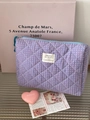 Detailed shot of a quilted checkered makeup bag with blue zipper and green handle - Handbag (Medium) / Purple
