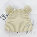 Creamy white knit beanie with bear ears and a silver heart patch for winter warmth - One Size / Beige