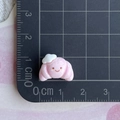 Detailed scale view of a 1.5cm pink resin croissant charm with a cute smile face - Pink Smile Croissant