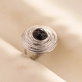 Macro detail of concentric spiral silver ring with a black marble textured gemstone - Silver Base-Black Stone