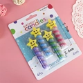 Set of 4 yellow star face birthday candles with colorful spiral stems for party cakes - Star Smiley Candle