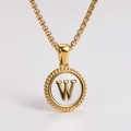 Detail of golden round pendant with white shell inlay and letter W engraving - Letter W