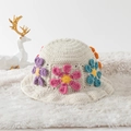 Handmade crochet bucket hat in beige featuring colorful floral patterns on a fur rug - One Size / Multicolor Daisy White Base