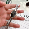 NAIDU women's quartz watch with oval dark grey dial and silver expansion steel band - Silver Band Gold Case Black Dial