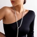 Detail of silver layered fringe necklace with a central knot on a model wearing black - Triple Layered Tassel Style (5581) / Silver