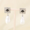Macro detail of French vintage earrings with square hammered metal and baroque pearls - Steel Evil Eye (KE115796-GC)