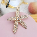 Detail of starfish hair clip with sparkling rhinestones on golden metal base - Style 08-Starfish Shape