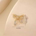Macro shot of cubic zirconia bow pendant showing precise 2cm by 1.9cm dimensions - Full Zircon Style MYYX00632 / Gold