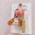 Detail of fabric dog keychain with heart metal hook, pink pompom and woven rope detail - Pearl Puppy