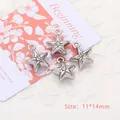 Macro shot of 4 mini silver-plated star charms with crystals and 11x14mm size marking - Star / Silver