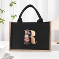 Canvas tote bag in black with floral letter R print and natural jute trim detail - Bronze Floral Letter R