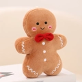 Detailed close-up of a brown plush gingerbread man doll with a red bow and embroidery - Smiling Gingerbread Man Pendant