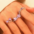 Bow tie silver rings set with purple heart-shaped gemstones on female finger - Purple Heart Bow Style (6398) / Purple
