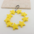 Yellow silicone star phone wrist strap with metal clasp on a minimalist stone base - Short Style / Yellow