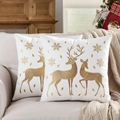 White Christmas pillow covers with gold deer and snowflake embroidery on a cozy sofa - Embroidered Gold Reindeer White Base/White