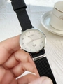 Close-up of DIUKOU silver quartz watch with black nylon strap held over white lace - Black