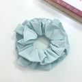 Detailed view of a large light blue pleated fabric scrunchie with soft texture - Blue (Three-layer)