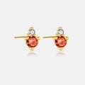 Detail of 3mm gold-plated sterling silver stud earrings with orange and white gemstones - January/Deep Red