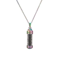 Detailed macro of a rainbow stainless steel cylinder perfume bottle pendant with black gravel - Black Agate