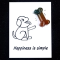 Brown and green dog bone crystal agate on a white card with puppy graphics - India Agate